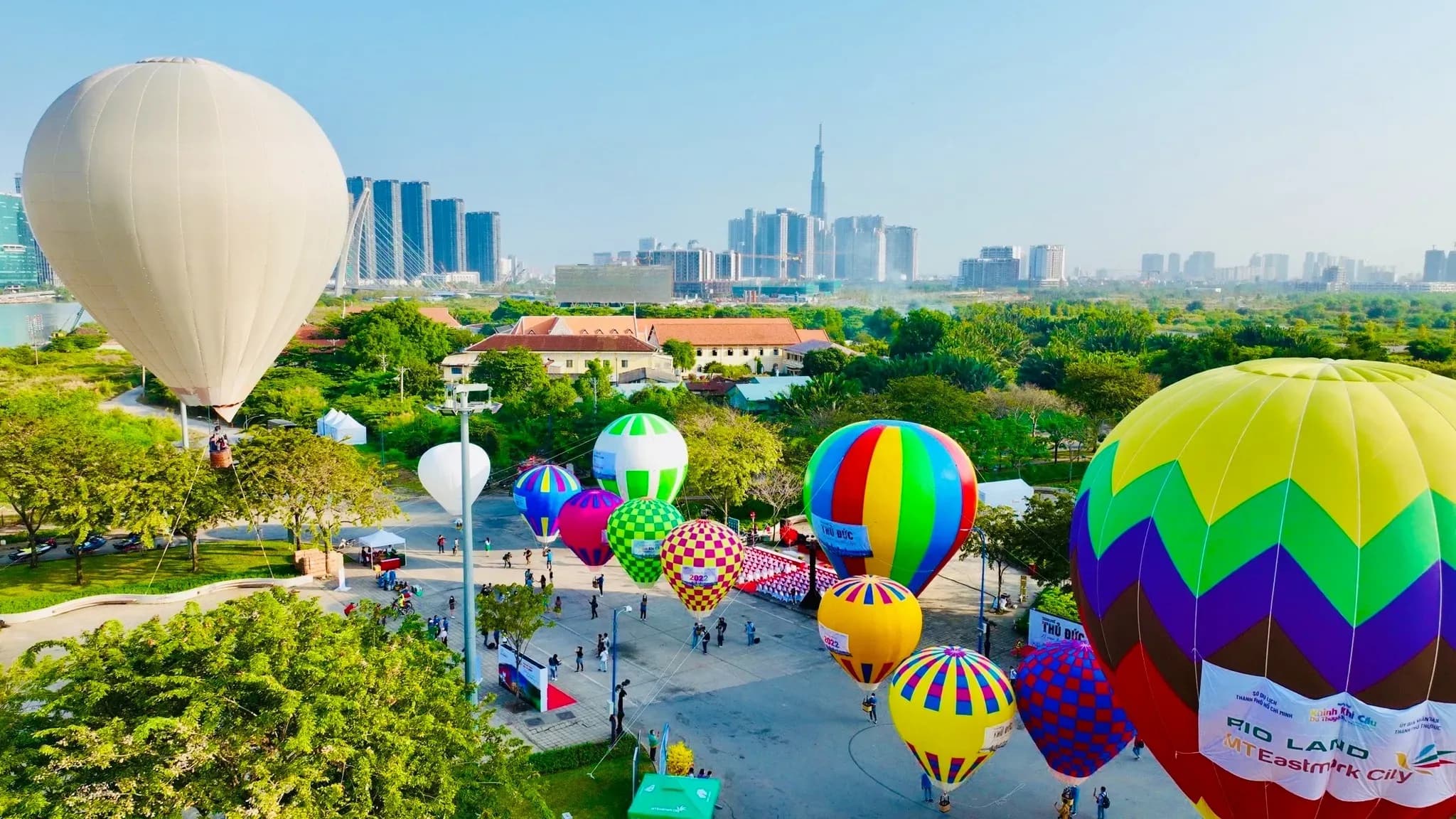 Hot air balloon event in a bustling city.