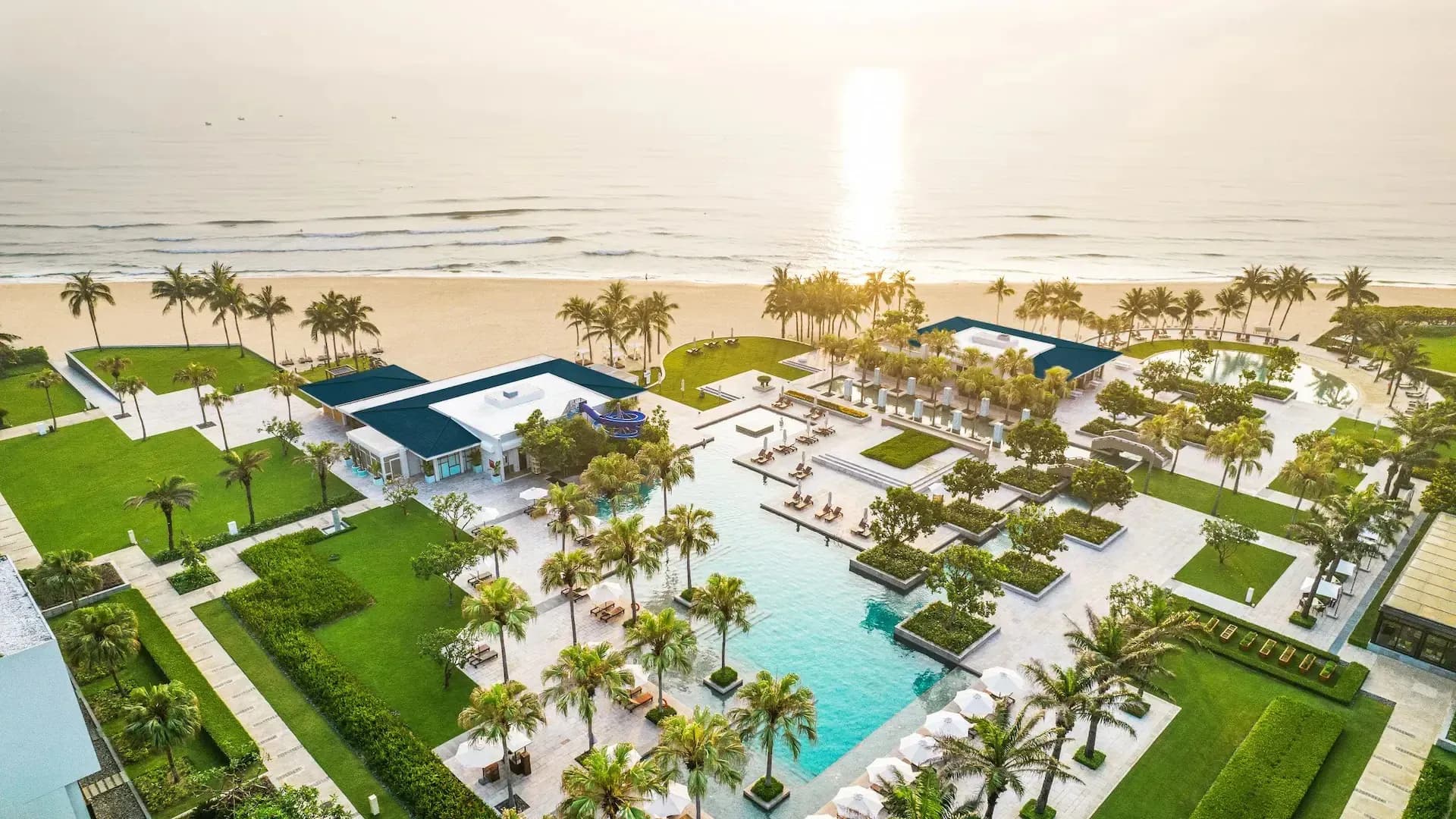 Aerial view of the resort featuring a private beach and refreshing pool.