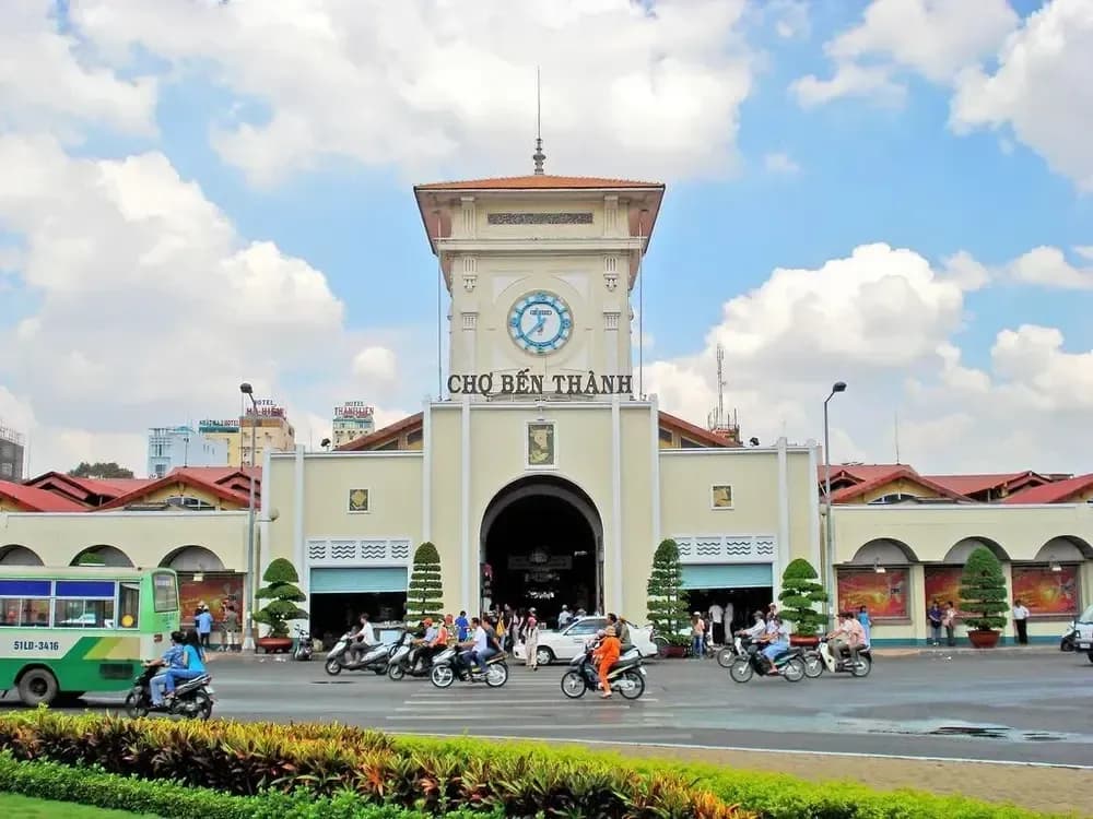 Modern view of Ben Thanh Market, featuring its iconic clock tower and bustling traffic.