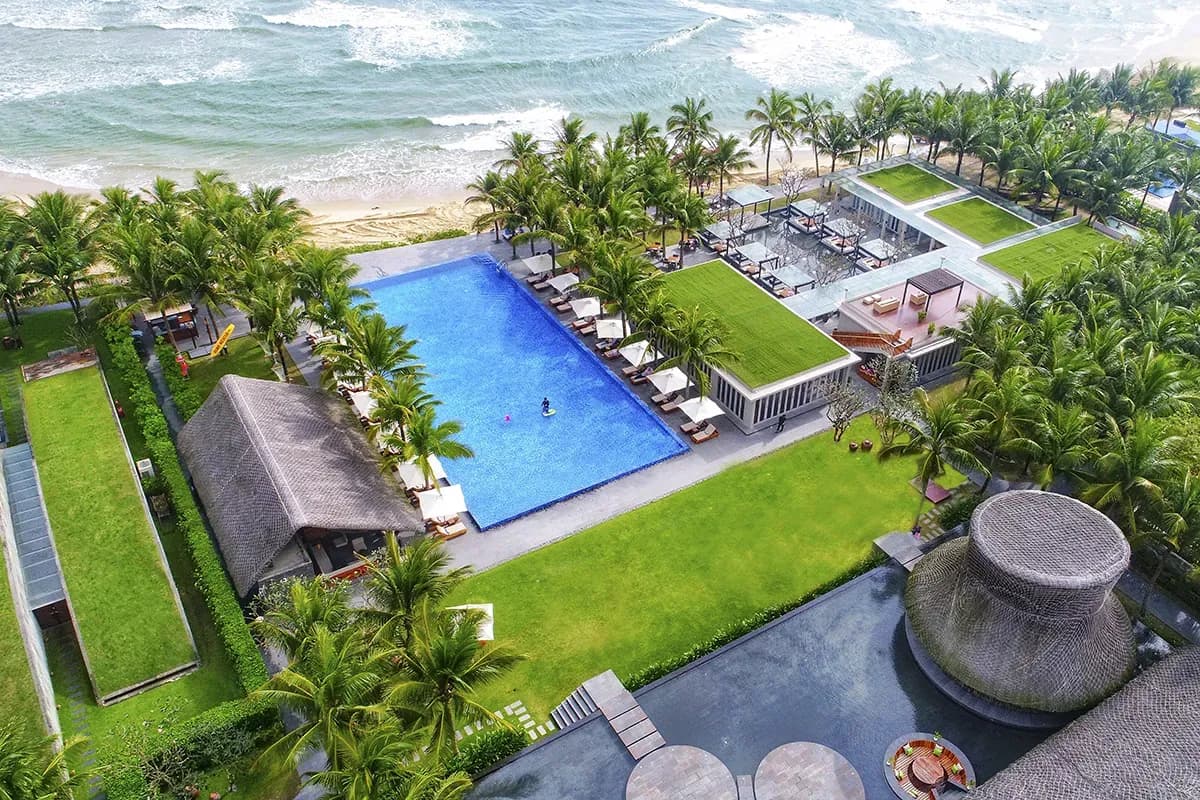 Panoramic view of the resort by the lush blue sea.