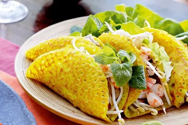 Crispy Hue banh khoai paired with fresh greens.