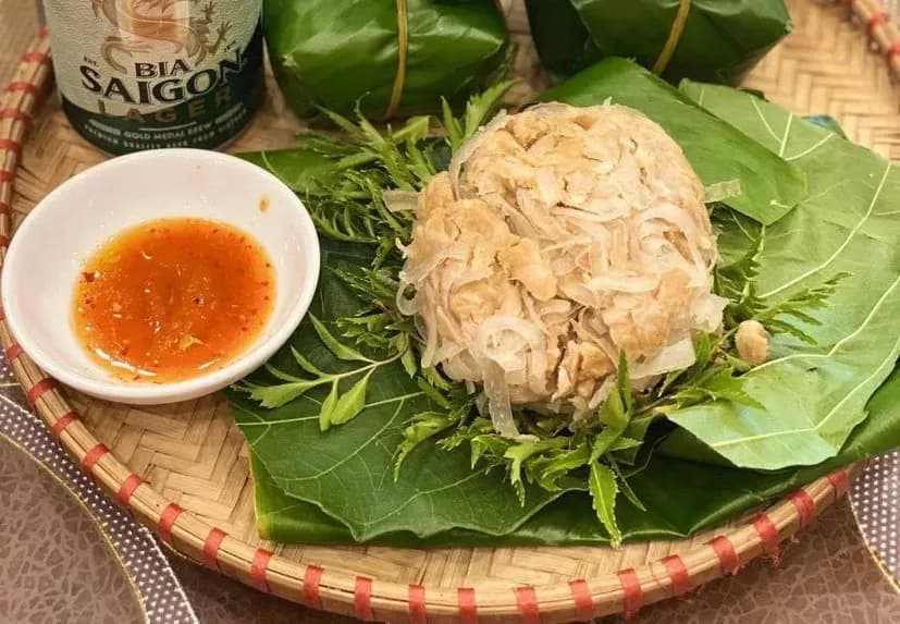 Nem nắm on fig leaves with vibrant chili sauce.