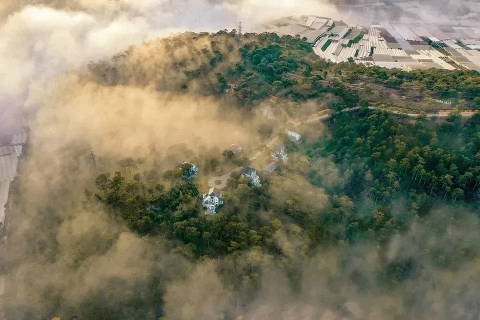 Kim Ngan Hill shrouded in mist, creating a mystical scene.