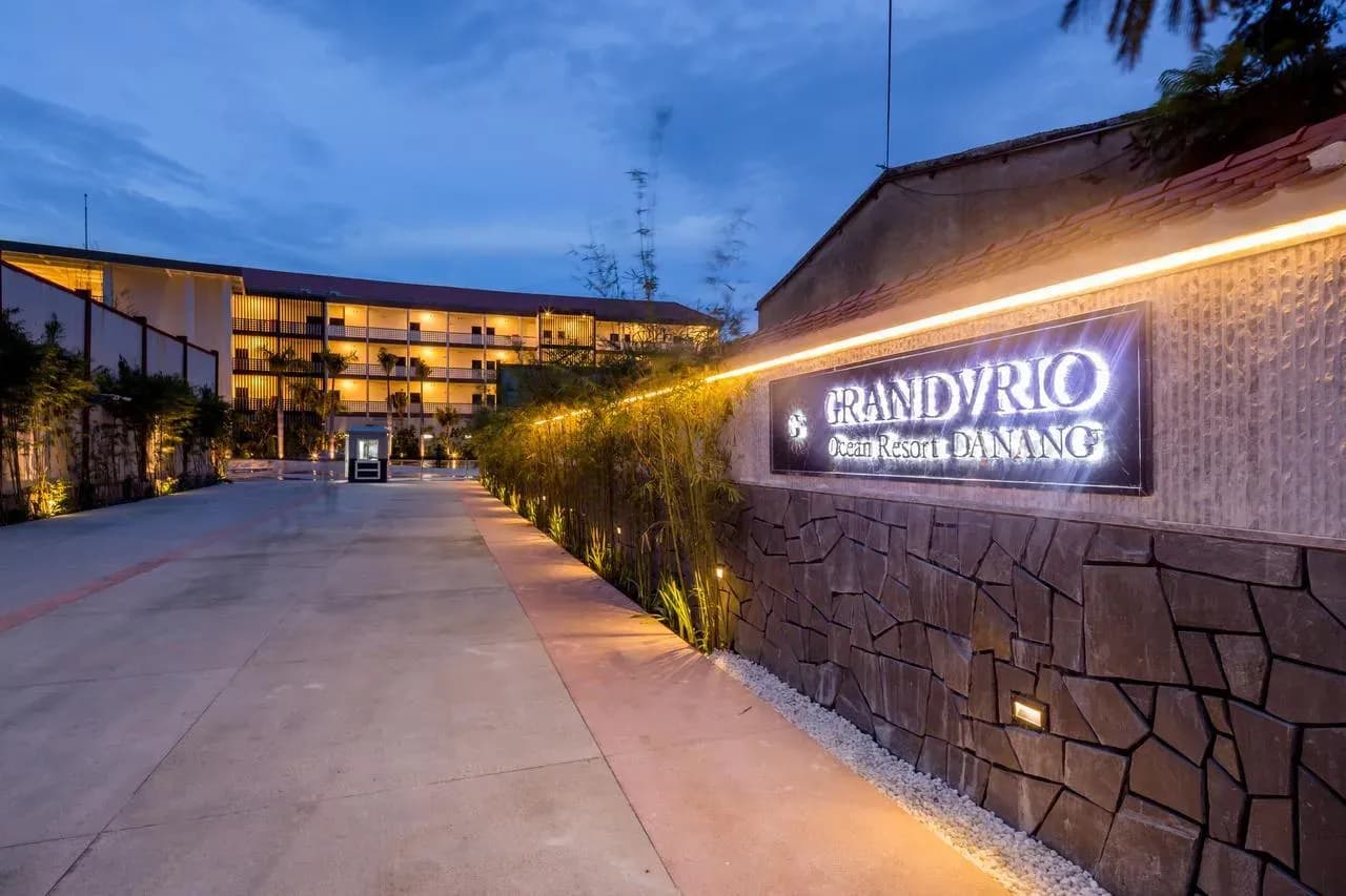 Image of the entrance to Grandvrio Resort Da Nang, glowing under golden lights.
